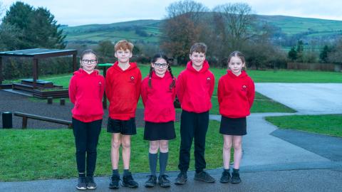 School uniform picture 5 pupils wearing red hoodies